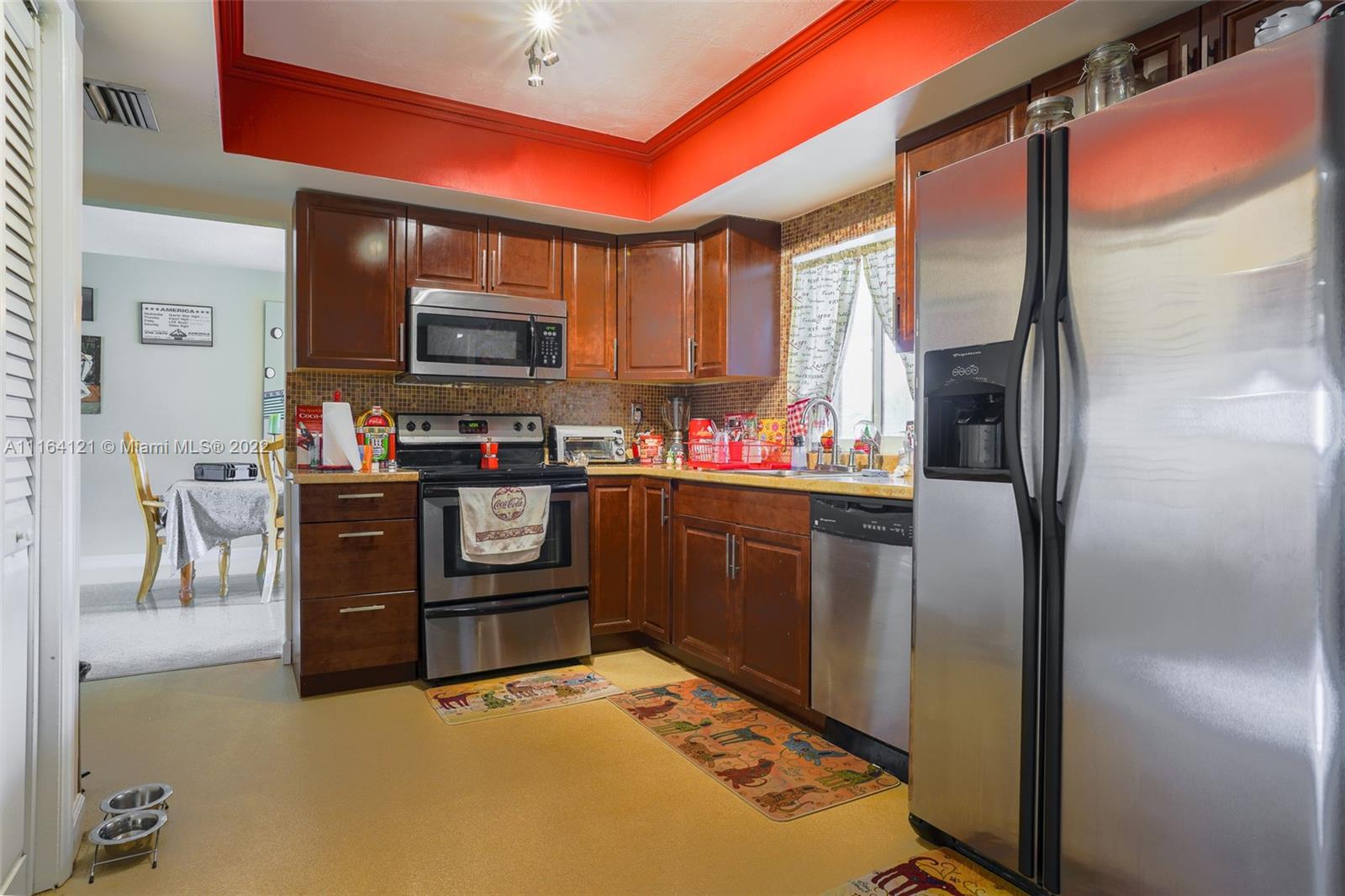 Cooper Colony Estates Cooper City, FL 33328 - Photo 12 of 33 a kitchen with stainless steel appliances granite countertop a refrigerator and a stove top oven
