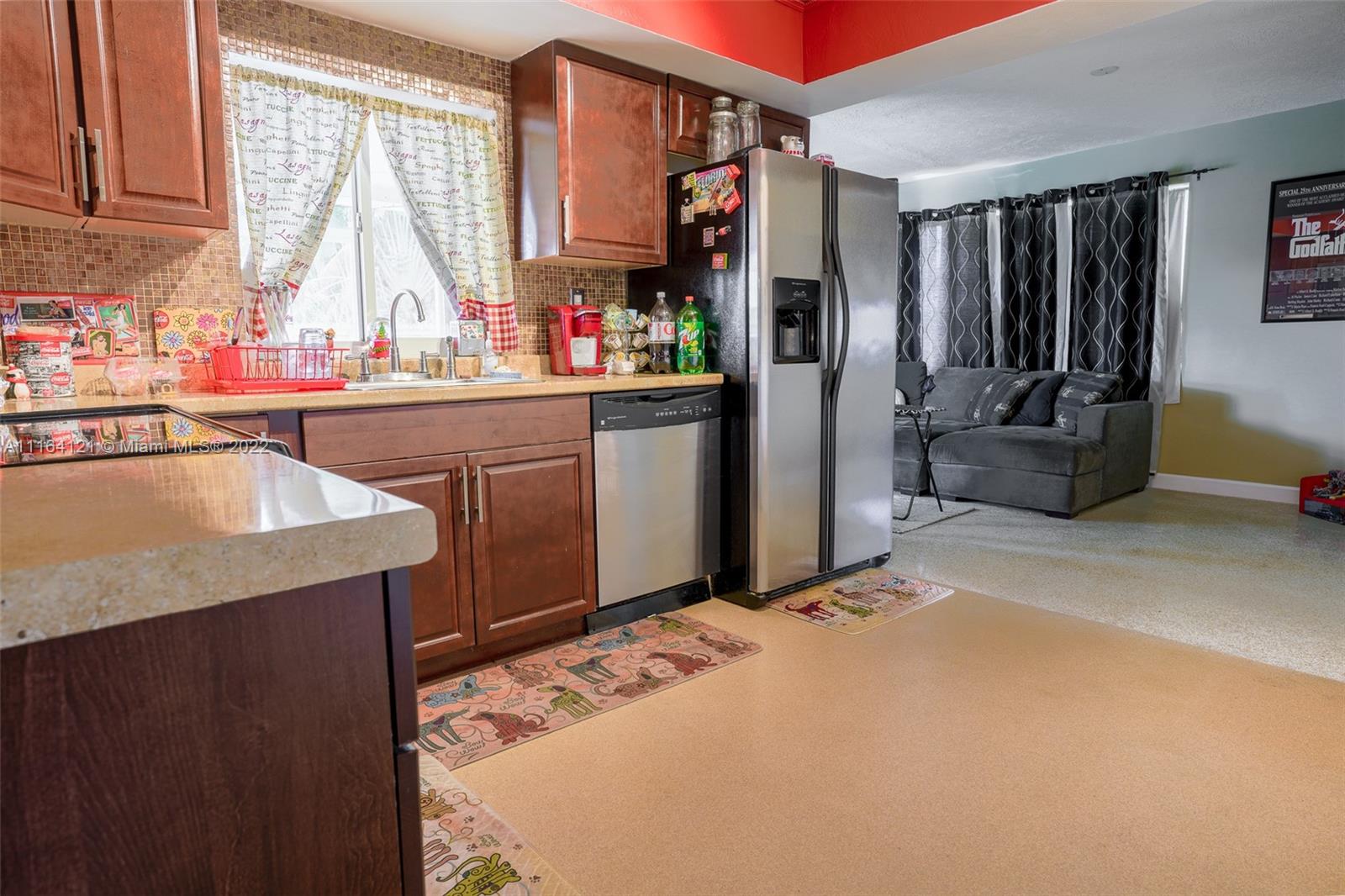 Cooper Colony Estates Cooper City, FL 33328 - Photo 17 of 33 a kitchen with stainless steel appliances granite countertop a sink and a refrigerator