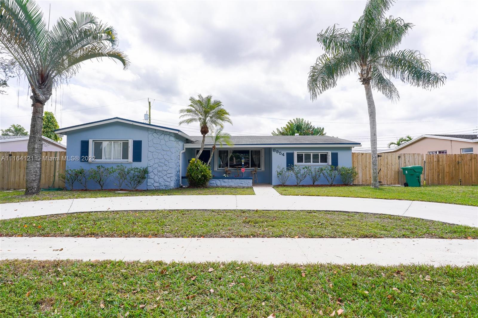 Cooper Colony Estates Cooper City, FL 33328 - Photo 2 of 33 a front view of a house with a garden and trees