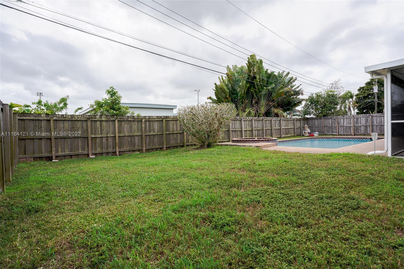 Cooper Colony Estates Cooper City, FL 33328 - Photo 25 of 33 a view of a yard with a large tree and wooden fence