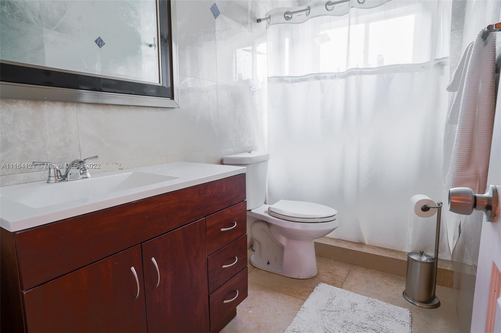 Cooper Colony Estates Cooper City, FL 33328 - Photo 6 of 33 a bathroom with a sink a toilet and shower