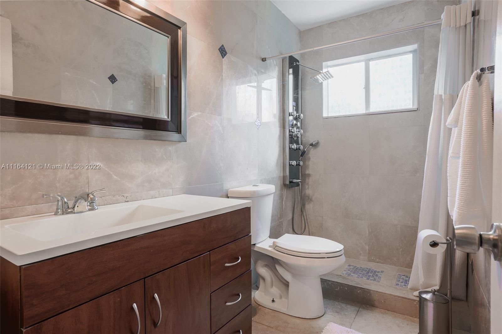 Cooper Colony Estates Cooper City, FL 33328 - Photo 7 of 33 a bathroom with a sink toilet and shower