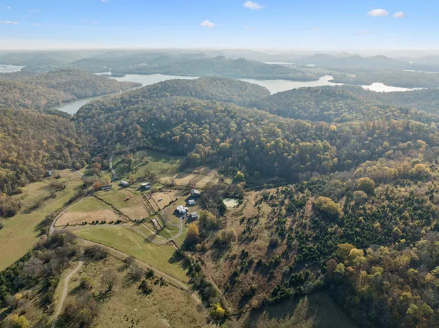 a view of a city of mountains in middle of green field