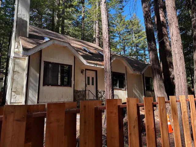 a view of a house with wooden fence