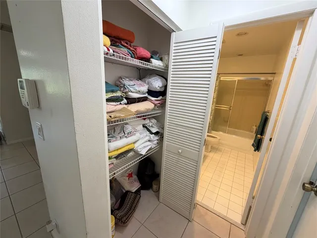 a bathroom with a granite countertop sink a mirror and a bathtub