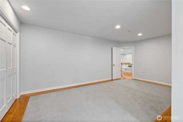 a bathroom with a granite countertop sink a toilet and a large mirror