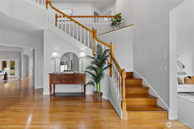 a view of entryway and hall with wooden floor