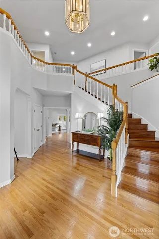 a view of entryway livingroom and hall with wooden floor
