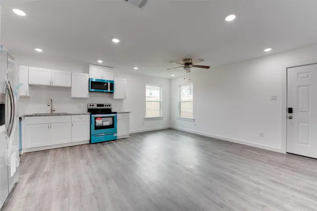 a kitchen with stainless steel appliances a refrigerator sink and microwave