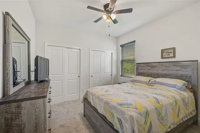 a bedroom with a bed and a large mirror