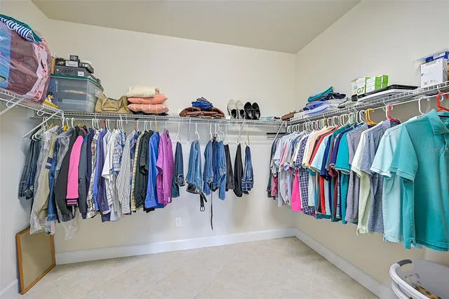 a view of walk in closet with clothes