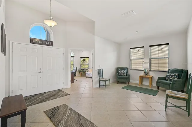 a living room with furniture and a dining table with wooden floor