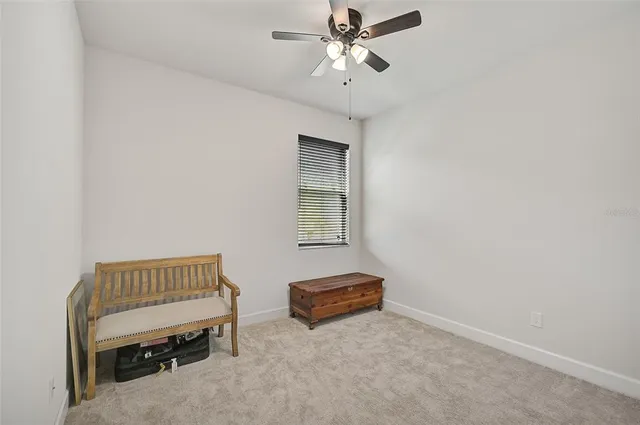 a living room with a couch and a chandelier