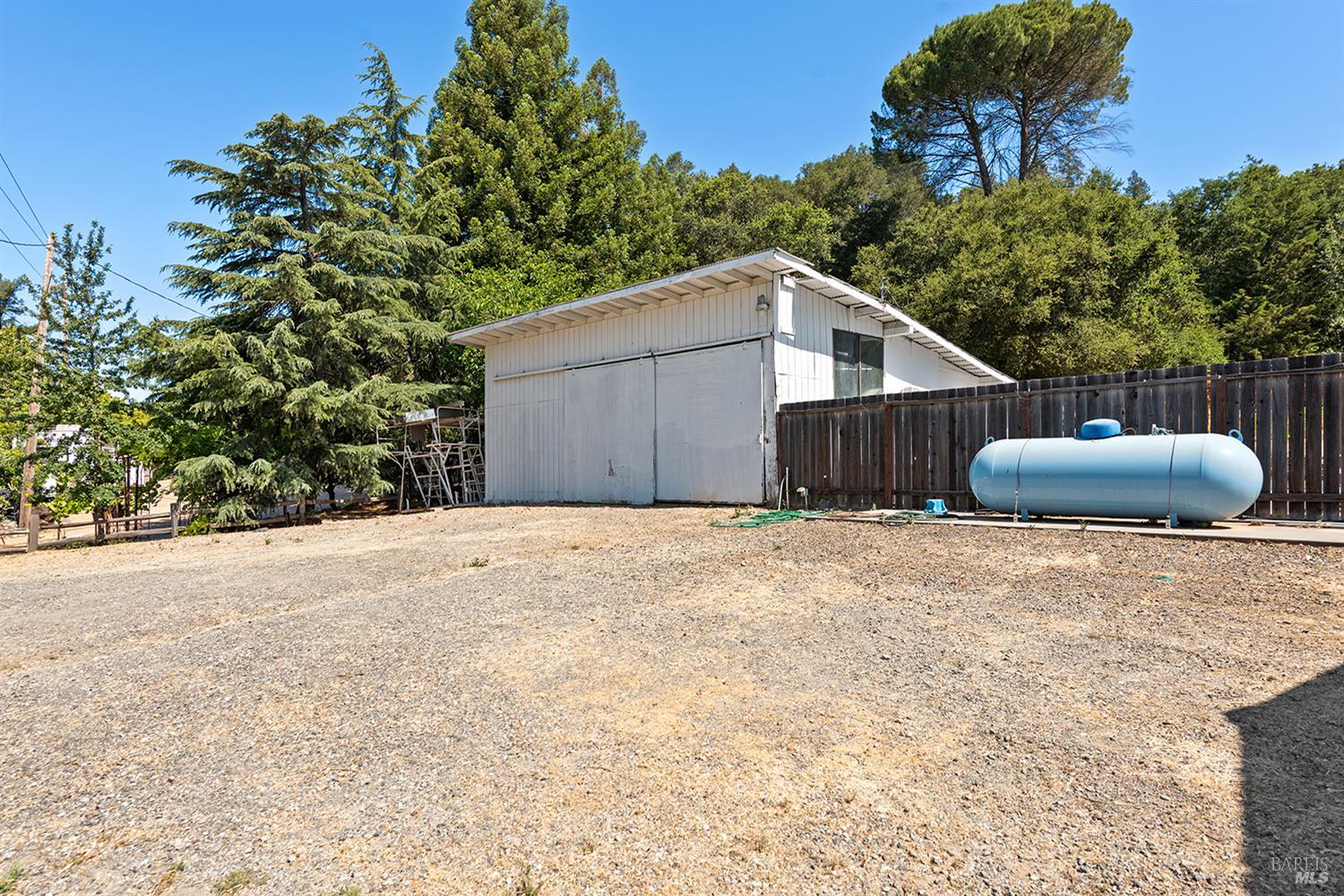 995 Dry Creek Road Healdsburg, CA 95448 - Photo 54 of 57 a house with a yard and a large tree