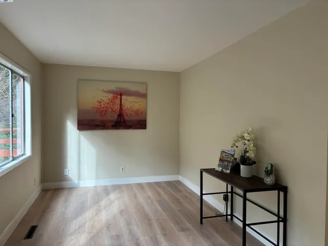 a workspace room with furniture and window