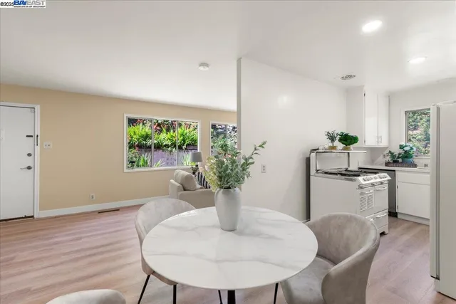 a dining room with furniture and potted plant