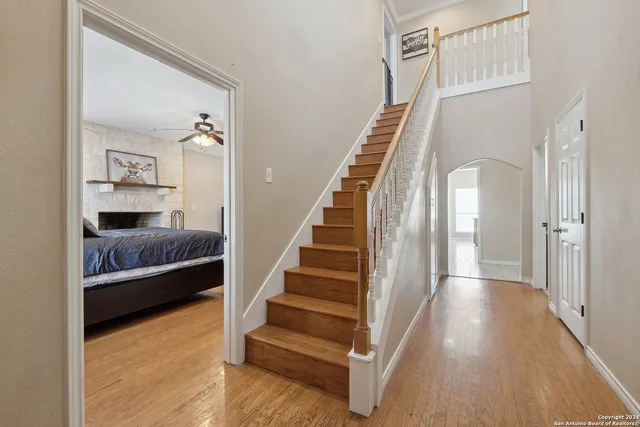 a view of bedroom and hall with wooden floor