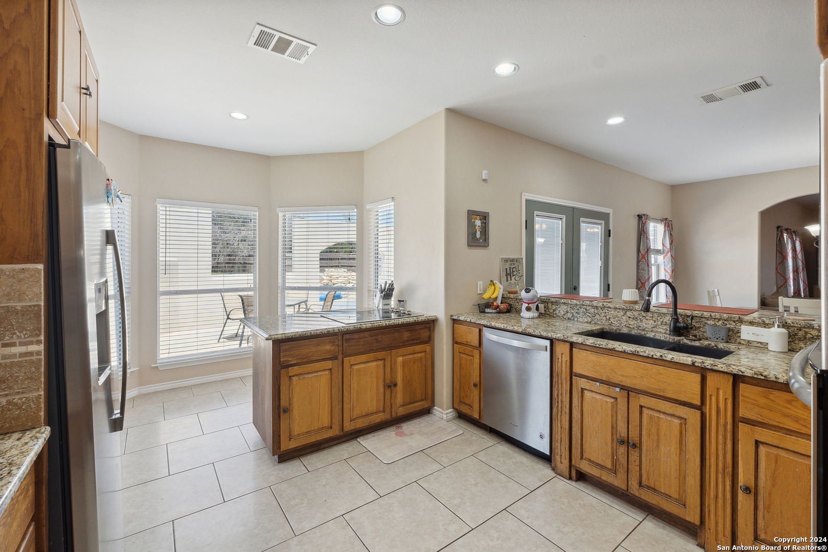 166 Desert Poppy Drive Bandera, TX 78003 - Photo 16 of 50 a large kitchen with stainless steel appliances granite countertop a sink and cabinets