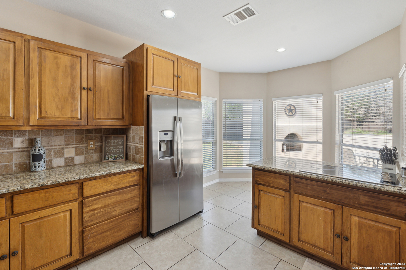 166 Desert Poppy Drive Bandera, TX 78003 - Photo 19 of 50 a kitchen with stainless steel appliances granite countertop a refrigerator and cabinets