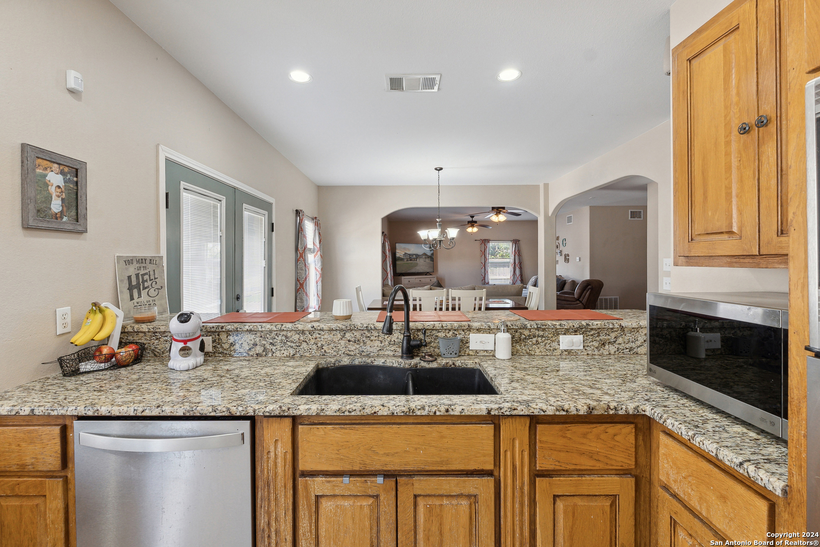 166 Desert Poppy Drive Bandera, TX 78003 - Photo 20 of 50 a kitchen with granite countertop a sink a stove and cabinets
