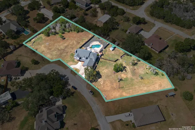 an aerial view of a house with a yard