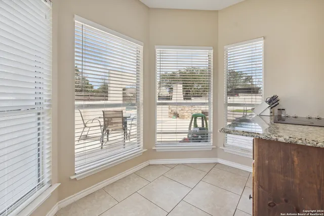 a kitchen with granite countertop a large window and a sink