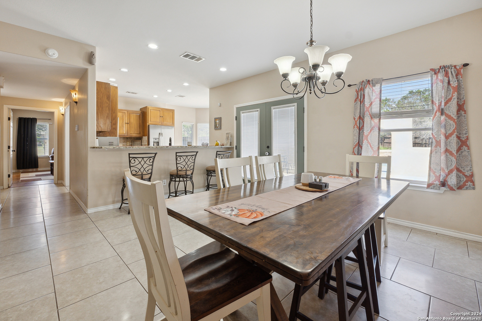 166 Desert Poppy Drive Bandera, TX 78003 - Photo 22 of 50 a view of a dining room with furniture and a chandelier
