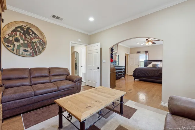 a living room with furniture and a wooden floor