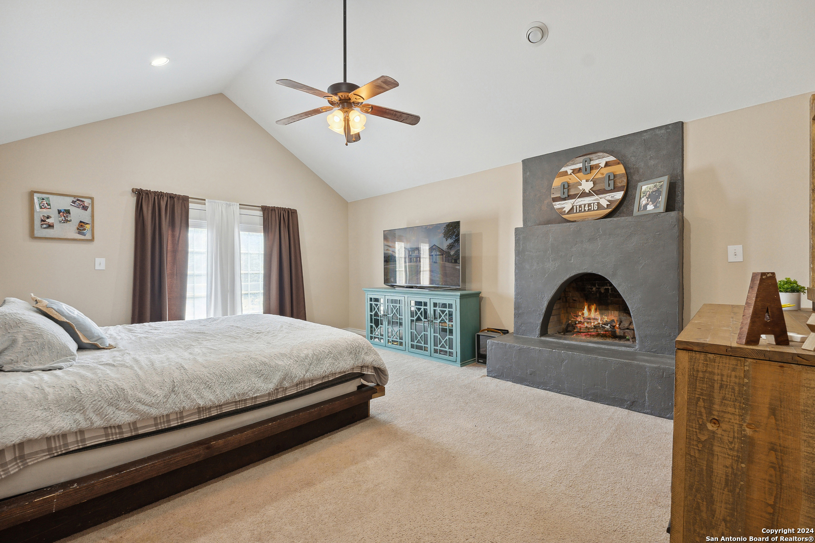 166 Desert Poppy Drive Bandera, TX 78003 - Photo 27 of 50 a bedroom with a bed and a fireplace