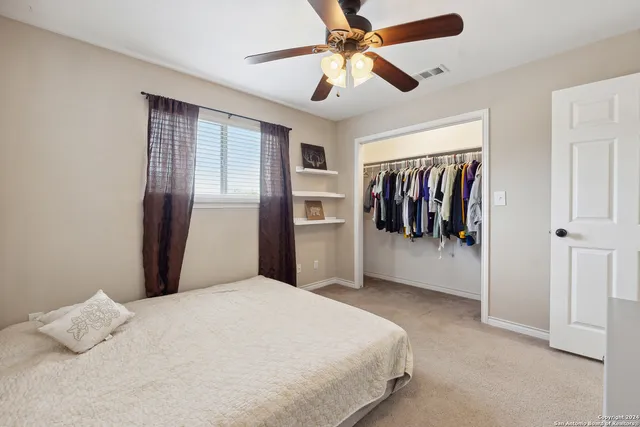 a bedroom with a large bed and a window