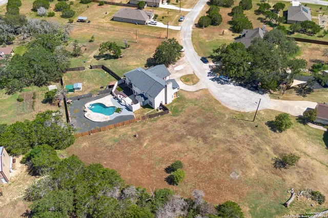 an aerial view of a house with yard