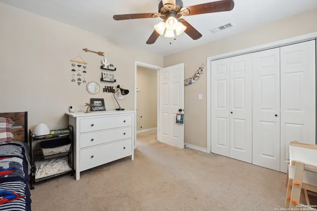 a room with a dresser and a chandelier