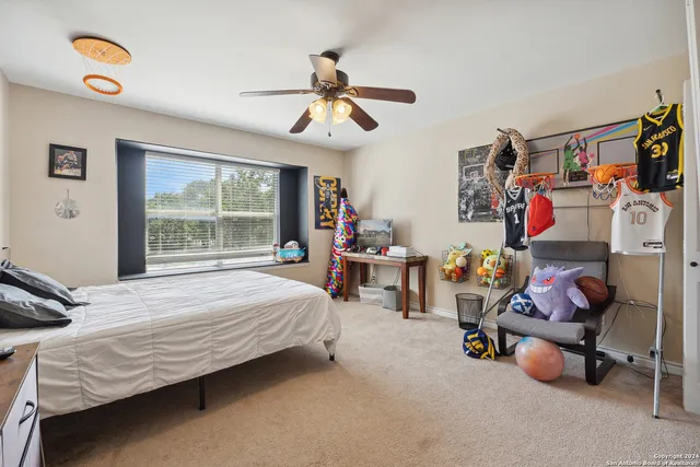 a bedroom with bed and a window