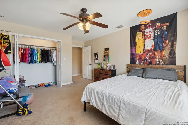 a bedroom with a bed dresser and furniture