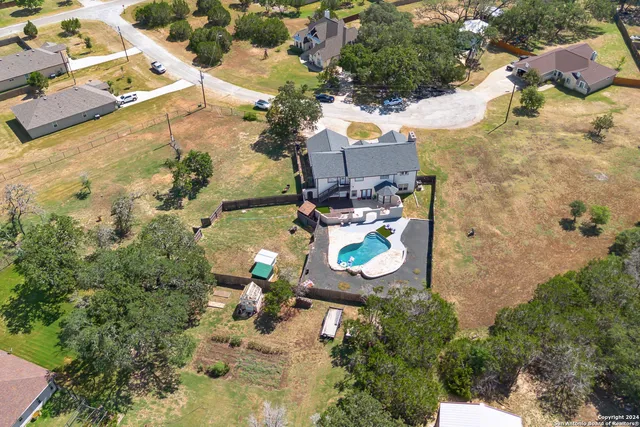 an aerial view of a house with a yard