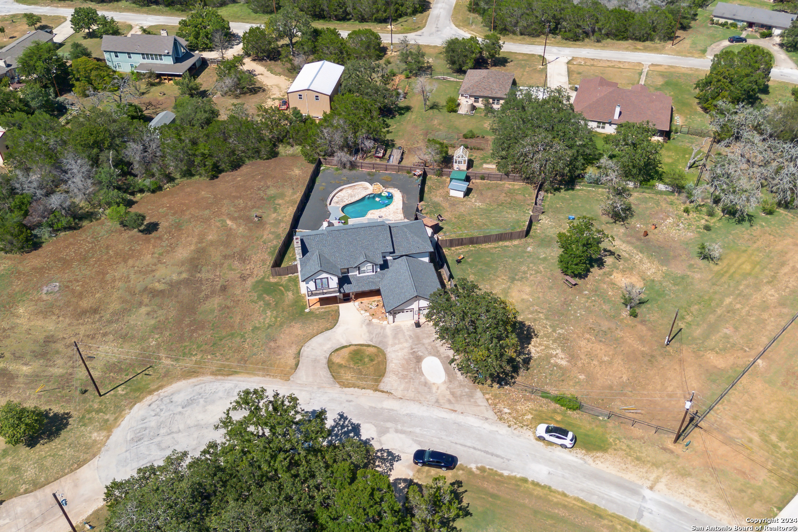 166 Desert Poppy Drive Bandera, TX 78003 - Photo 46 of 50 an aerial view of a house with a swimming pool
