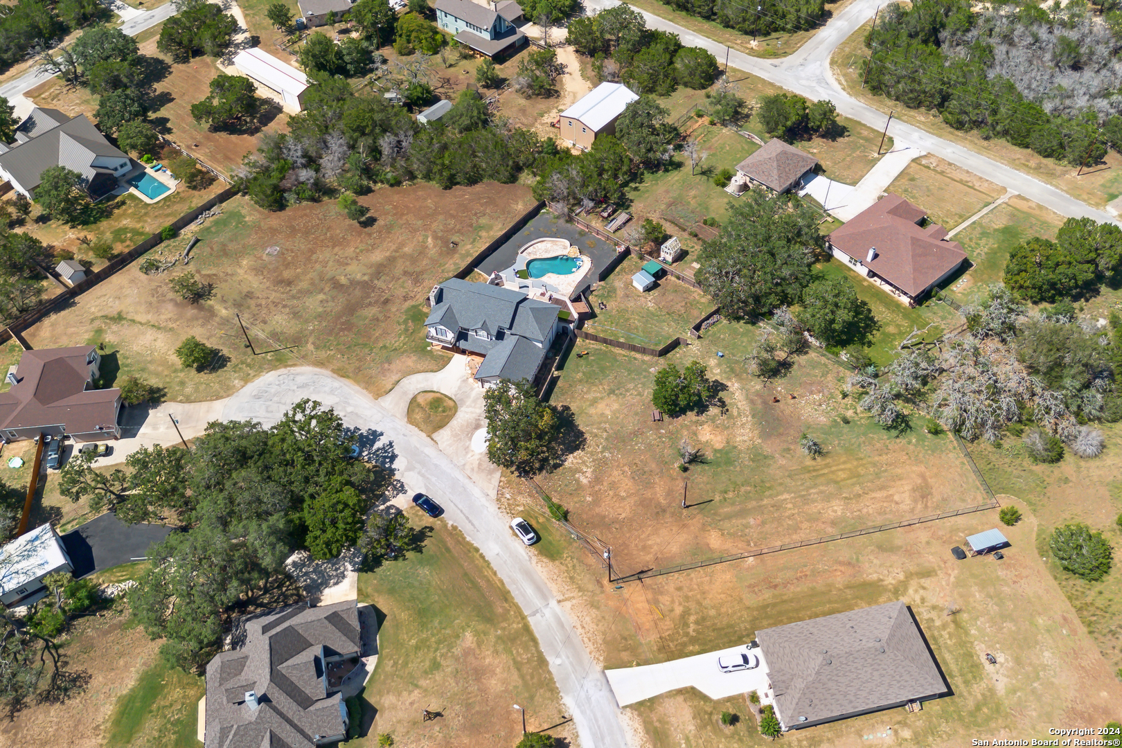 166 Desert Poppy Drive Bandera, TX 78003 - Photo 47 of 50 an aerial view of a house with a yard and lake