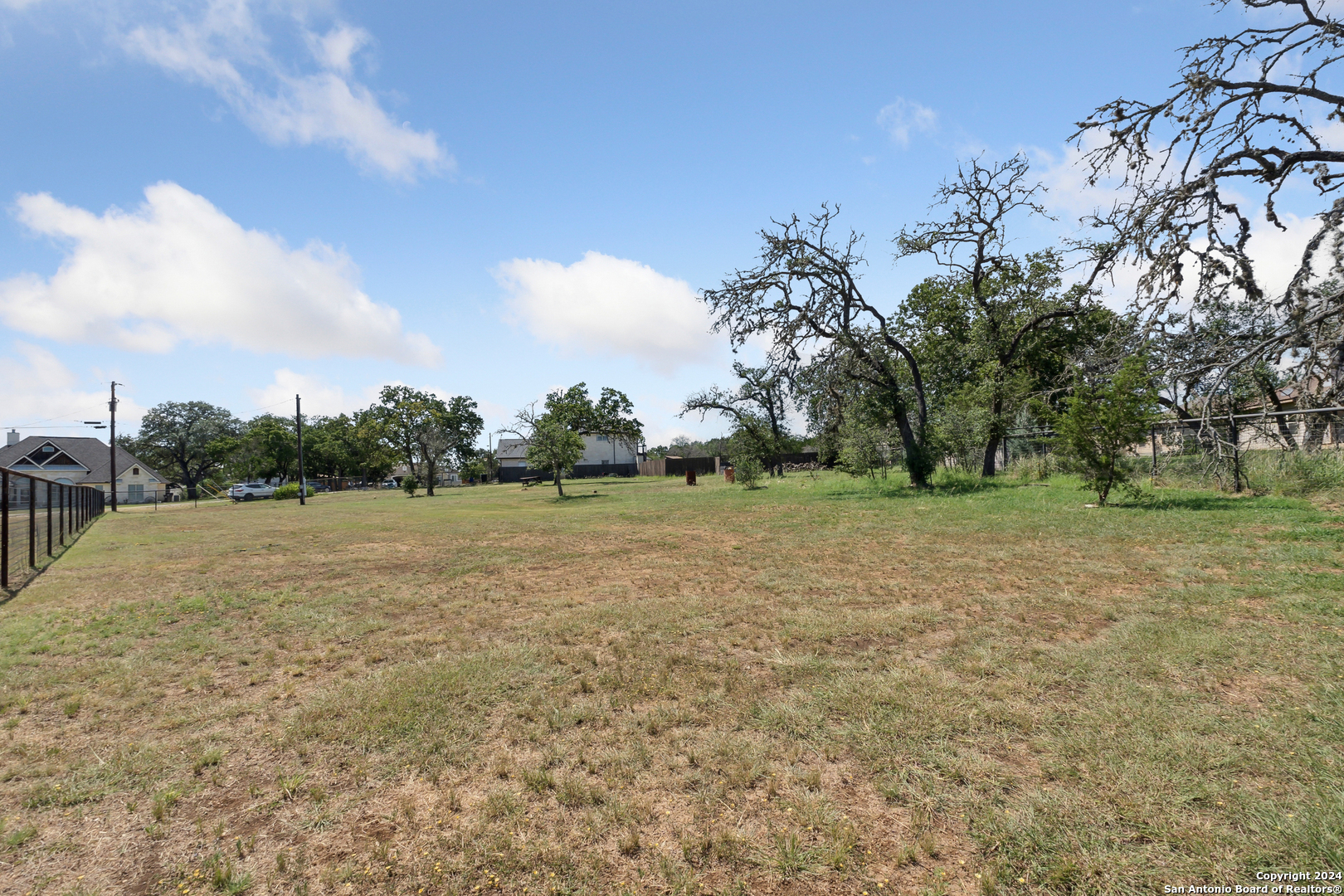 166 Desert Poppy Drive Bandera, TX 78003 - Photo 48 of 50 a view of dirt field with trees in background