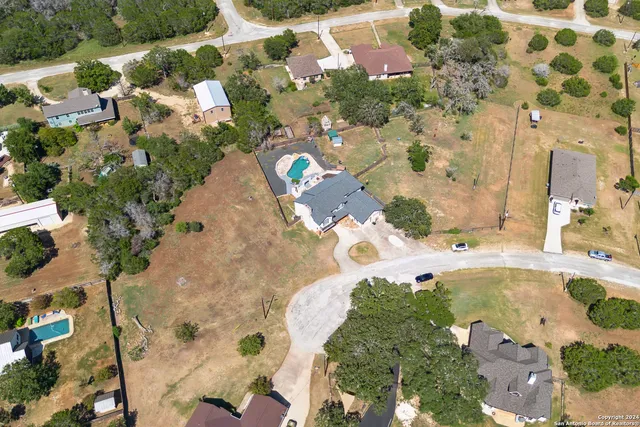 an aerial view of a house with a yard