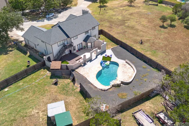 swimming pool view with a seating space