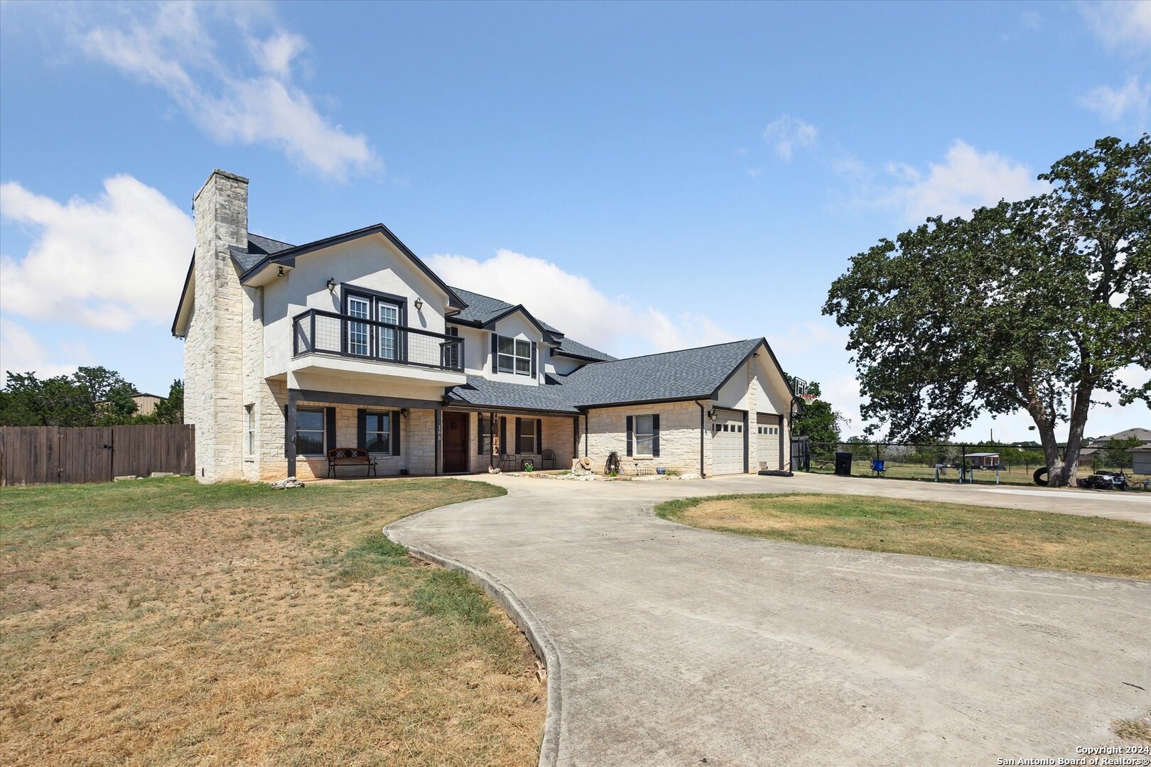 166 Desert Poppy Drive Bandera, TX 78003 - Photo 5 of 50 a front view of a house with a yard