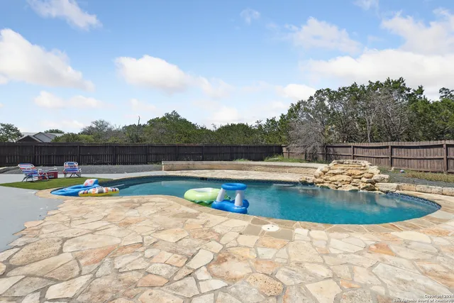a view of swimming pool with seating space