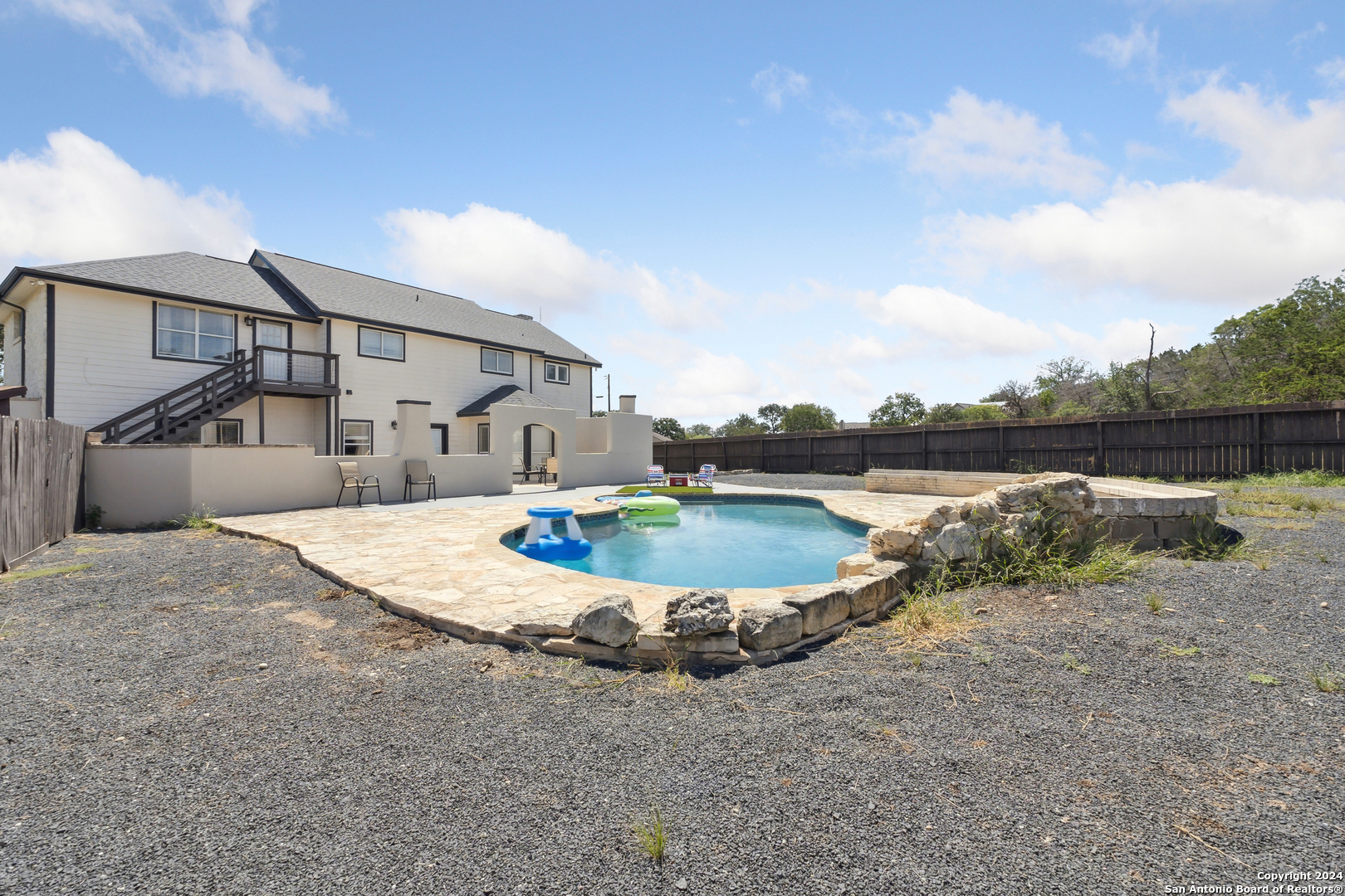 166 Desert Poppy Drive Bandera, TX 78003 - Photo 9 of 50 a swimming pool with outdoor seating and plants