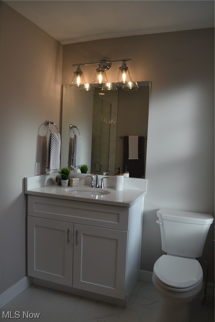 3693 Stoer Road Shaker Heights, OH 44122 - Photo 24 of 35 Bathroom with toilet, tile flooring, large vanity, and a notable chandelier