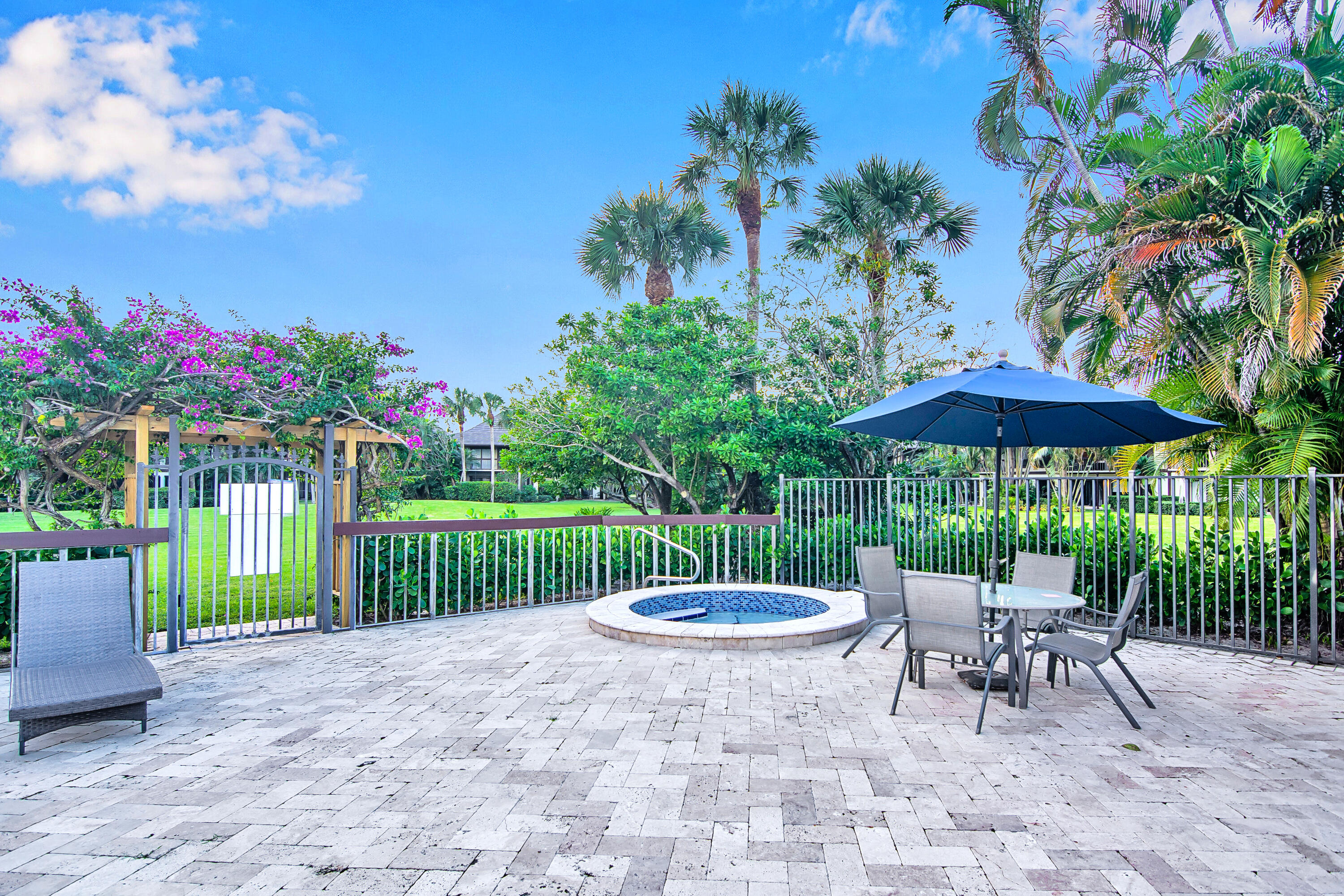 13334 Polo Club Road, Unit 218 Wellington, FL 33414 - Photo 12 of 13 a view of a table and chairs in patio under a umbrella