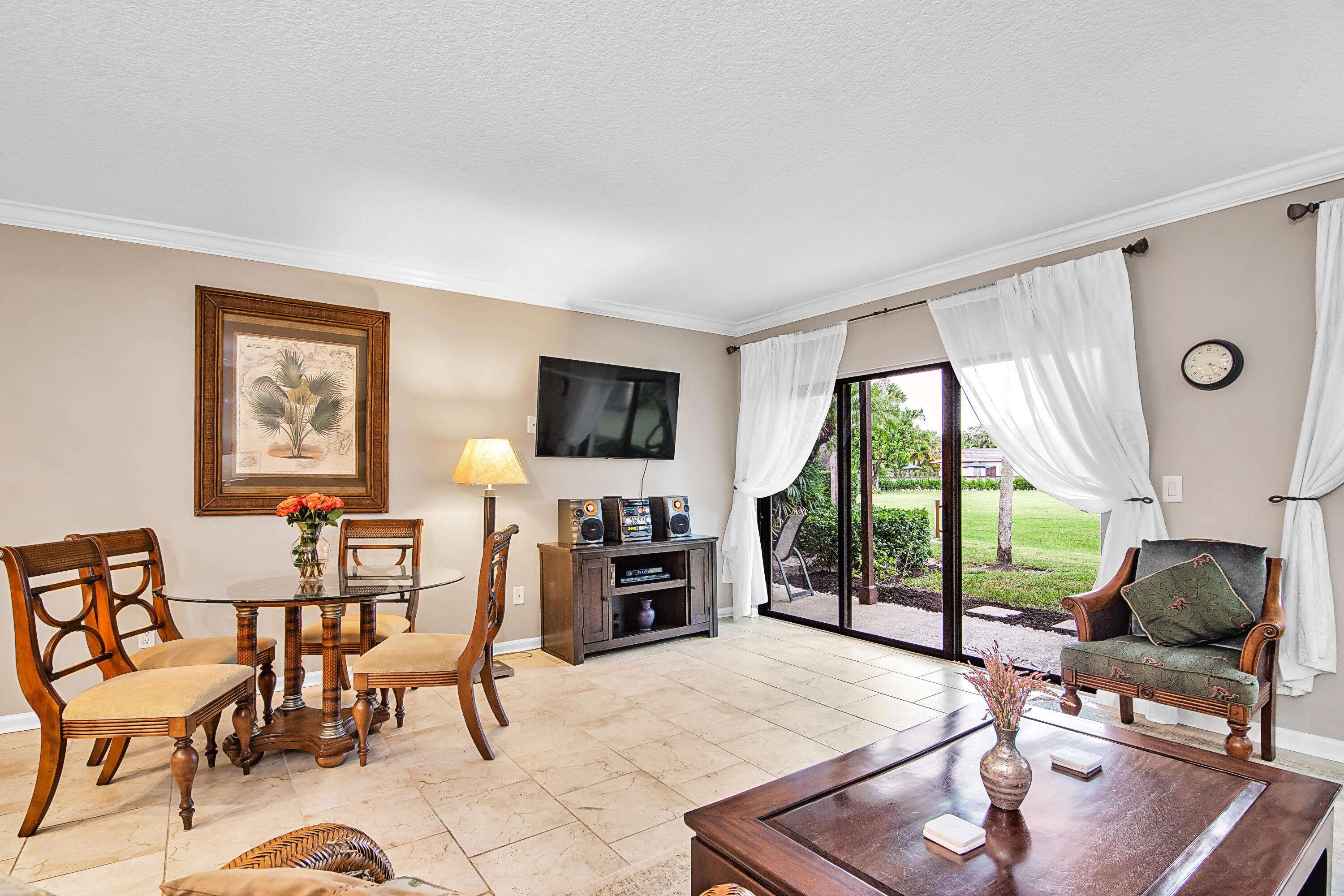 13334 Polo Club Road, Unit 218 Wellington, FL 33414 - Photo 4 of 13 a living room with furniture a flat screen tv and large windows