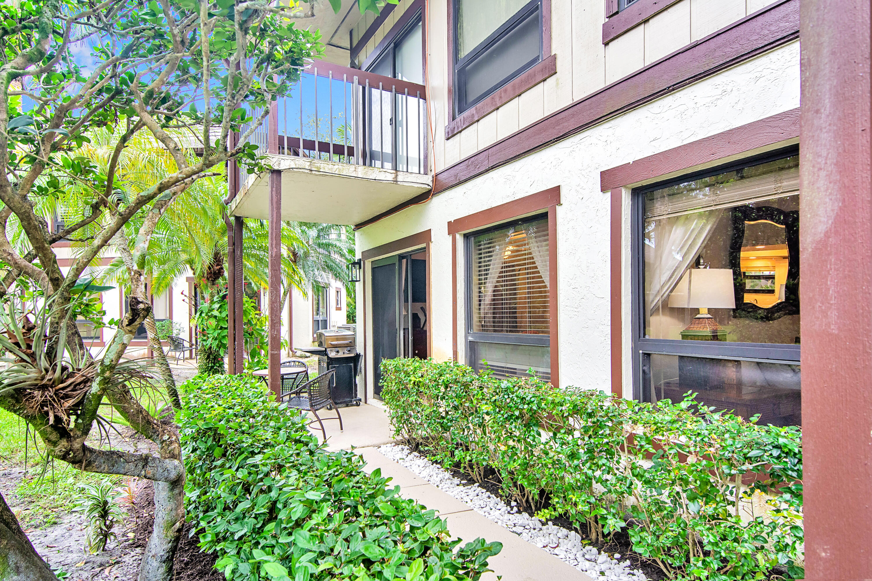 13334 Polo Club Road, Unit 218 Wellington, FL 33414 - Photo 10 of 13 a front view of a building with an outdoor seating