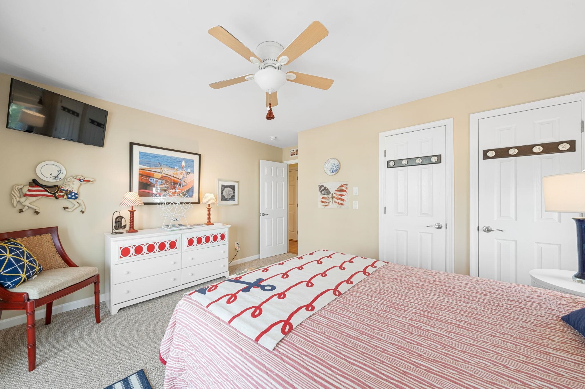 704 South Commonwealth Avenue Strathmere, NJ 08248 - Photo 15 of 50 a bedroom with a bed and a chandelier