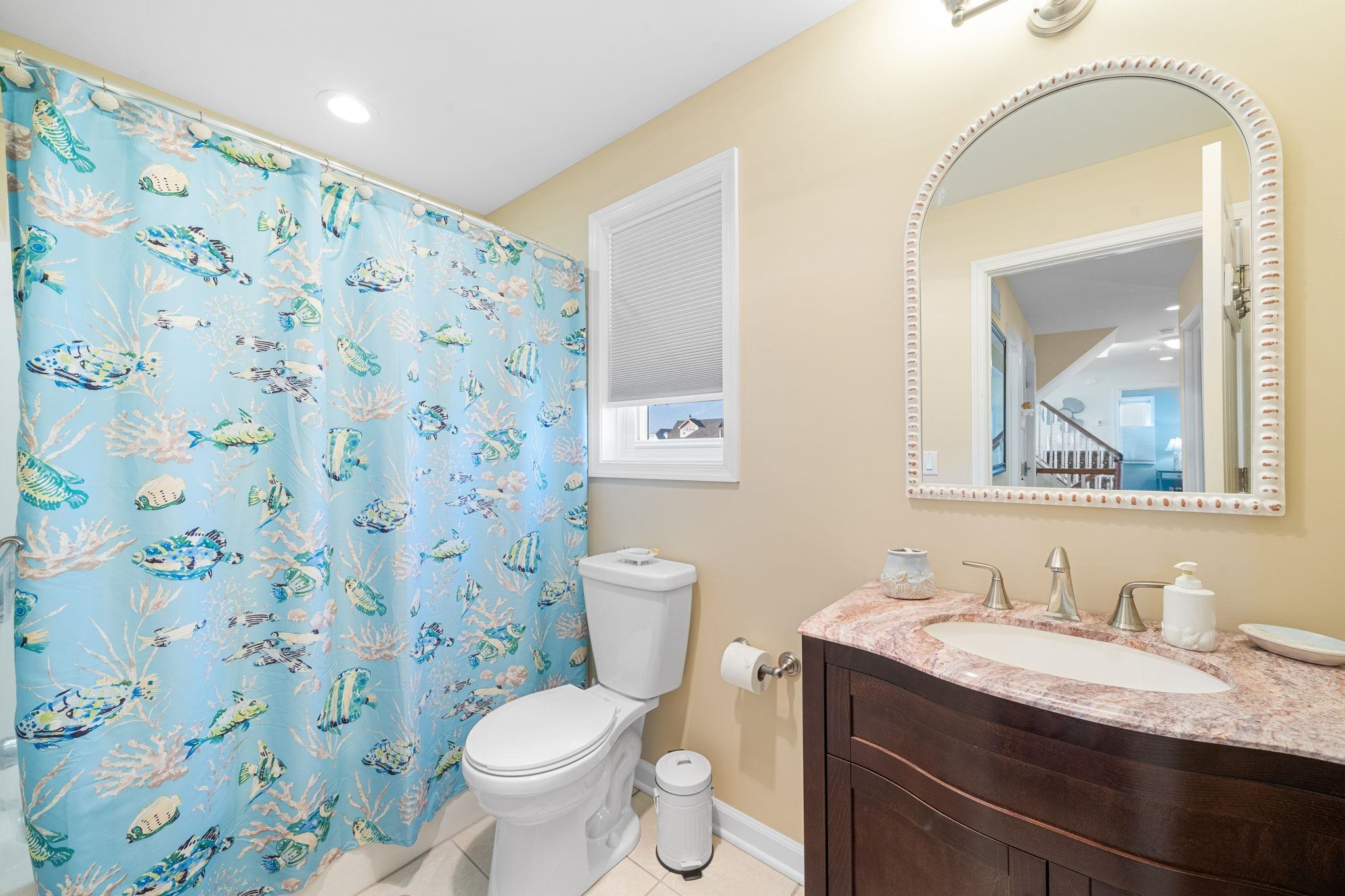 704 South Commonwealth Avenue Strathmere, NJ 08248 - Photo 16 of 50 a bathroom with a granite countertop sink a toilet and a mirror