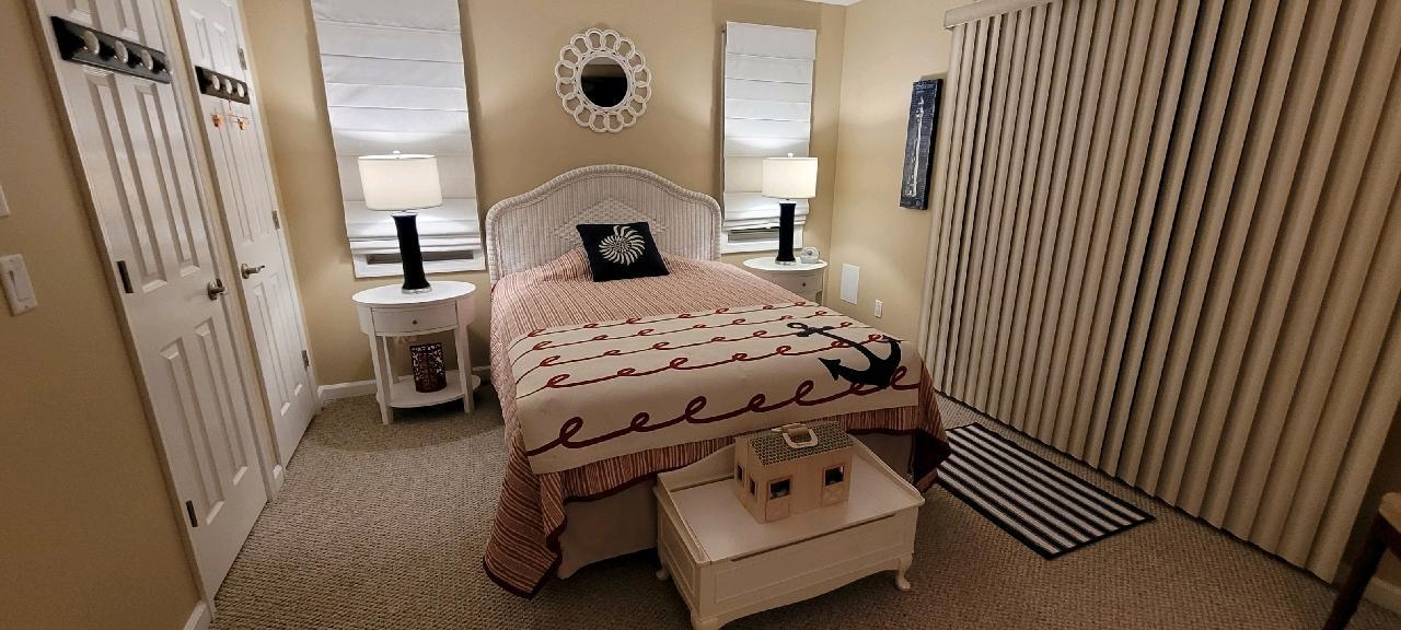 704 South Commonwealth Avenue Strathmere, NJ 08248 - Photo 17 of 50 a bedroom with a bed and a mirror